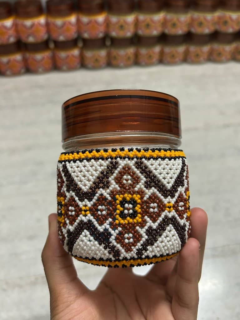 Blue and orange moti kaam beaded jar held in hand, navy and orange single piece