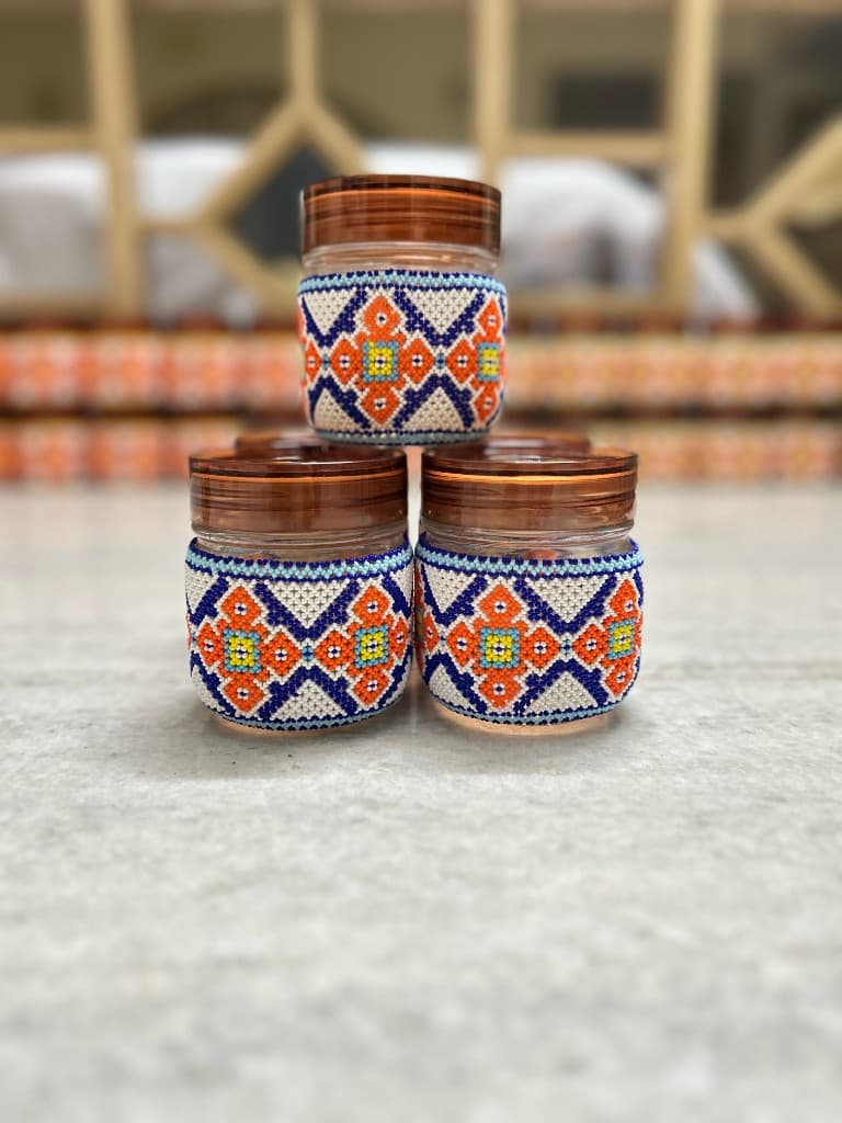Red and yellow beaded jar trio pyramid stack on marble
