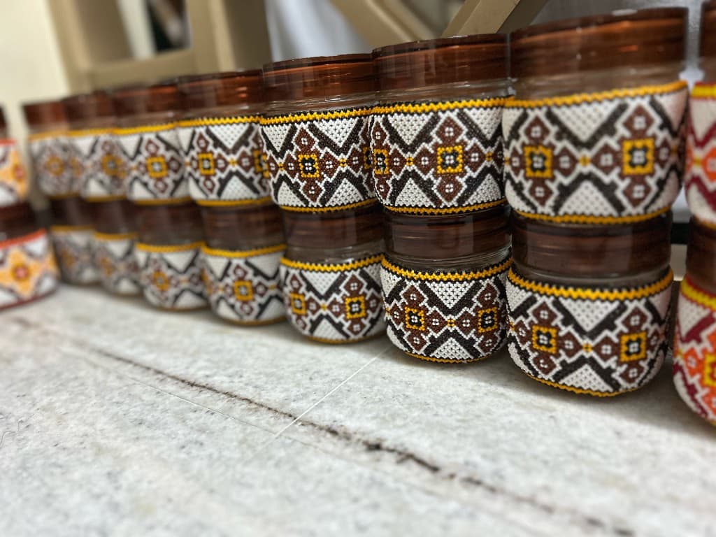 Forest green and red beaded jar trio pyramid stack on marble