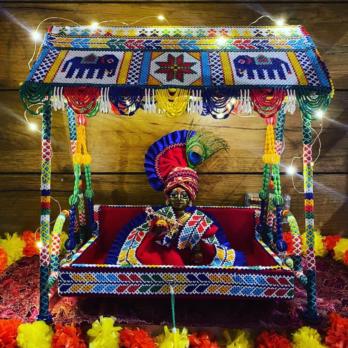 Beaded Laddu Gopal jhula with colourful ornamentation and hanging tassels