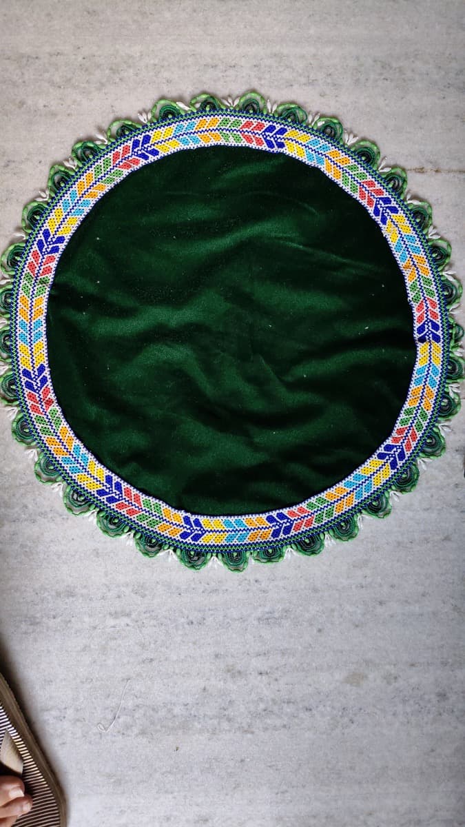 Beaded Laddu Gopal singhasan with intricate multicoloured beadwork patterns