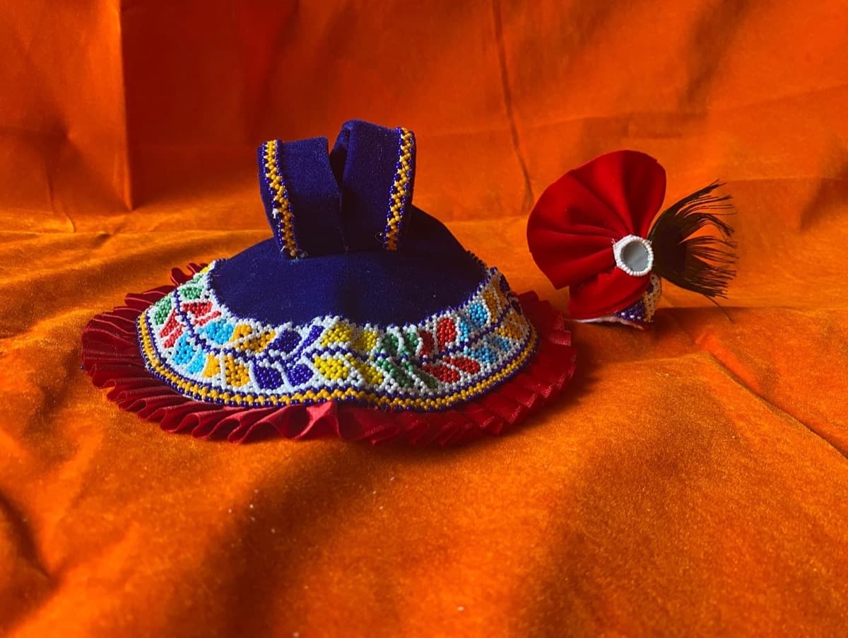 Laddu Gopal vagha set with blue beaded outfit and red frills with red turban on orange fabric